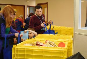 Volunteer creating the holiday meal bags.