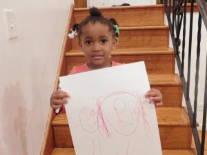 kid holding a drawing
