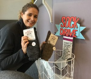 woman holding two socks