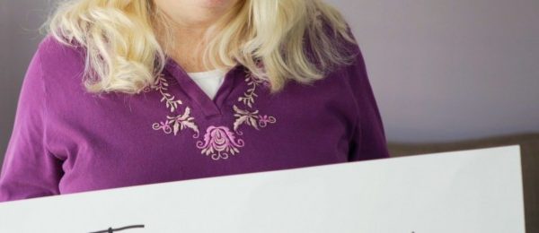 a woman wearing a violet blouse