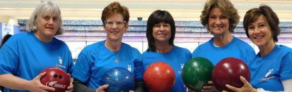 girls holding a bowling ball