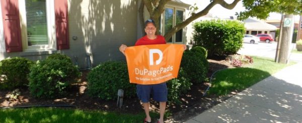 man holding a dupagepads banner