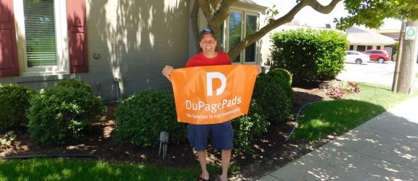 man holding a dupagepads banner