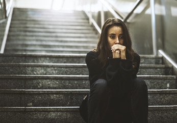 a woman sitting and thinking